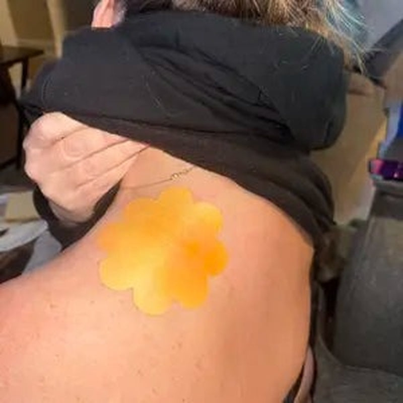 Warming relief patch applied to a shoulder